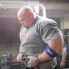 A muscular man displaying a strongly built physique.