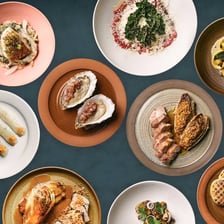 A gourmet tasting a carefully prepared dish to assess its flavors.