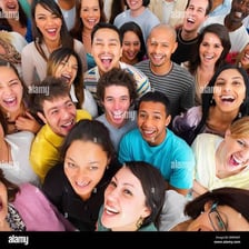 A group of people smiling broadly for a photograph