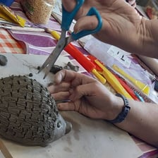 A piece of clay being shaped into a finished form.