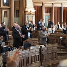 Legislators seated and debating in a legislative chamber