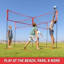 Players competing in a beach volleyball game beside a net