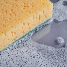 Water spreading through the porous material of a sponge