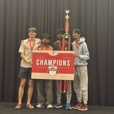 A student celebrating a win at a quiz competition.