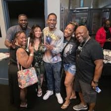 Friends laughing together during a comedic performance