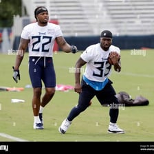 A running back carrying an American football