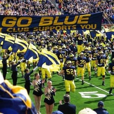 University of Michigan Wolverines athletes in maize and blue uniforms.