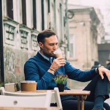 A person remaining outside a café instead of leaving.