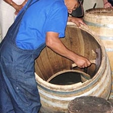A cooper assembling a wooden barrel