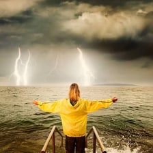 A person standing confidently in difficult weather