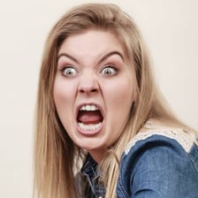 A person displaying an intensely angry facial expression.