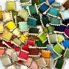 Wooden bobbins holding sewing thread