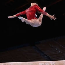 A gymnast demonstrating precise balance and controlled movement.