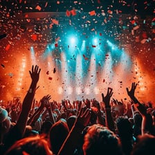 A concert audience reacting with excitement to a live performance