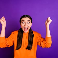 A person expressing lively enthusiasm with raised arms.