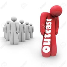 A person standing apart from a larger group