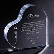 A handwritten love note beside a heart-shaped keepsake, suggesting sentimental feeling.
