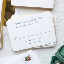A formal invitation card showing an RSVP request