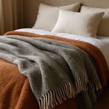 Soft blankets arranged on a bed