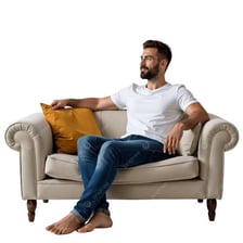 A person relaxing comfortably on a sofa.