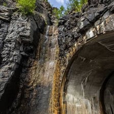 A roadway passing through a tunnel bored into a mountain