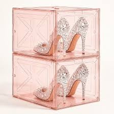 An open shoebox containing high-heeled shoes