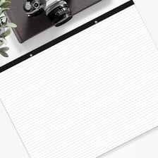 Several paper notepads arranged on an office desk.