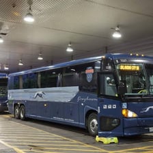 A Greyhound intercity bus at a bus terminal.