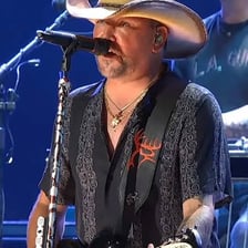 Jason Aldean performing onstage with a microphone