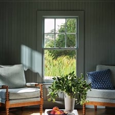 A room illuminated by sunlight streaming through its windows.