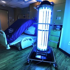 A hospital room being thoroughly disinfected by a cleaner