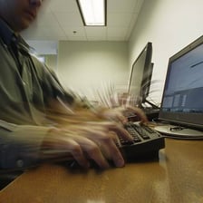 A person entering text on a computer keyboard