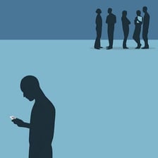 One person standing apart while a social group ignores them
