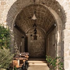 A stone passage beneath a curved arch.