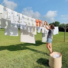 Clothes and linens hanging from an outdoor clothesline