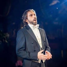 A male opera singer performing a tenor role
