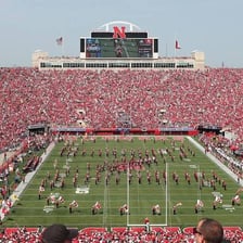 Fans wearing Nebraska Cornhuskers colors at a stadium