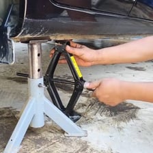 A person demonstrating a practical method with hand tools.
