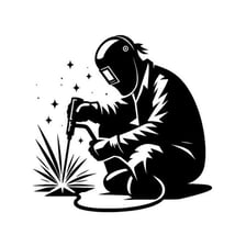 A welder joining metal pieces with a bright welding torch