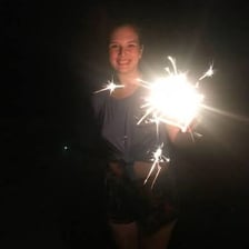 A sparkler giving off a few final fading sparks