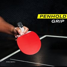 A table-tennis player holding a racket with the penhold grip.
