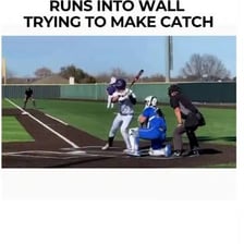 A baseball outfielder reaching to catch a fly ball.