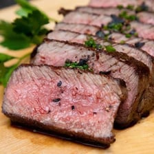A sliced steak with a visibly pink center.