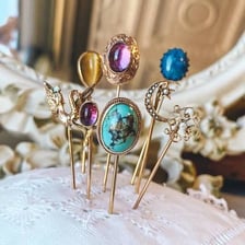 Decorative pins displayed against a necktie.