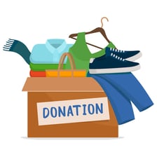 A charity collection area containing donated clothing and household goods.