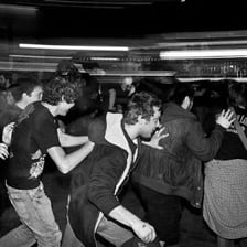 A concert crowd participating in a mosh pit.