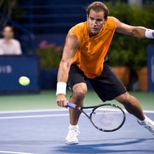 Pete Sampras playing tennis in a match.