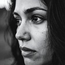 A person shown with a notably gloomy and melancholic expression.