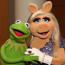 Kermit the Frog standing with Miss Piggy