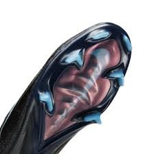 The studded sole of a soccer shoe showing its traction-providing cleats